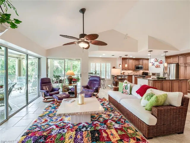 Vaulted great room with double set of sliders to the L-shaped lanai