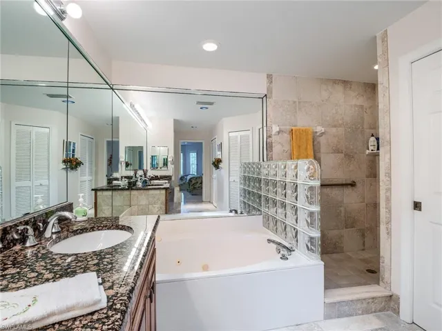 Master bath features jetted tub and updated walk-in shower