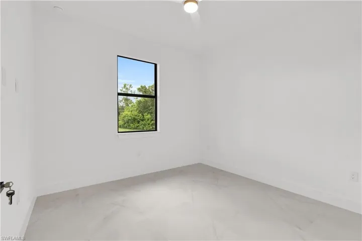 Spare room with baseboards and light marble finish flooring