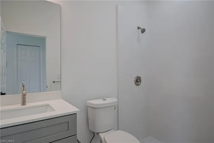 Bathroom featuring vanity and tiled shower