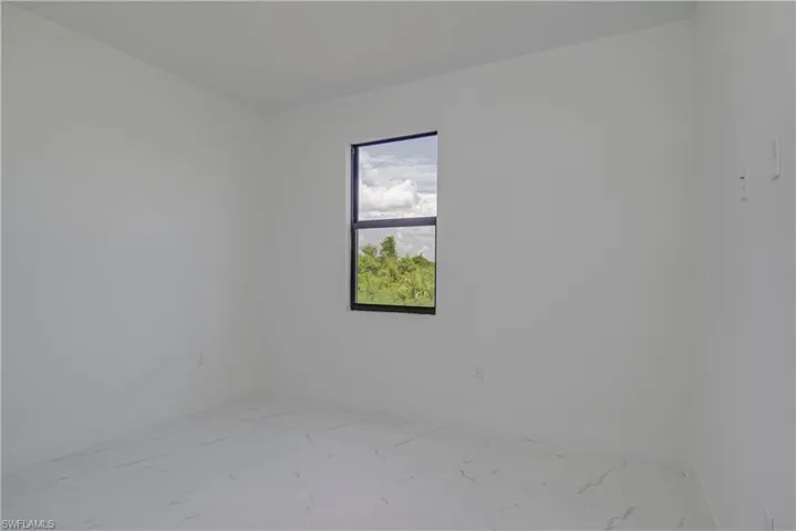 Empty room with marble finish flooring and baseboards