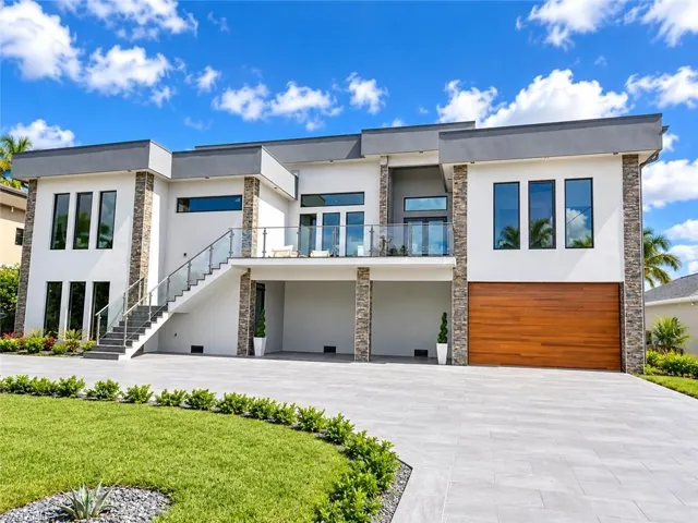 Contemporary exterior featuring stone accents and a flat roofline