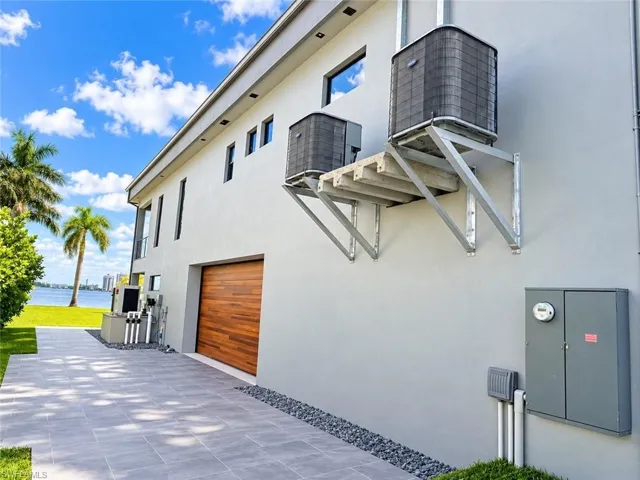 Smooth stucco exterior with a wood-finish garage door