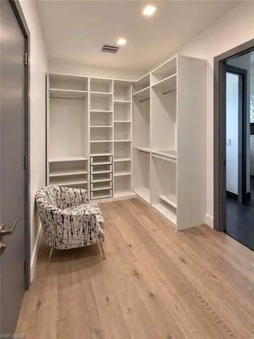 White built-in closet system with shelving and hanging rods