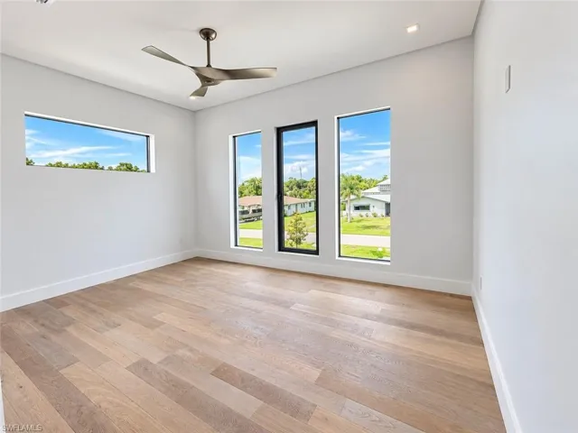 Light wood-finish flooring with white walls