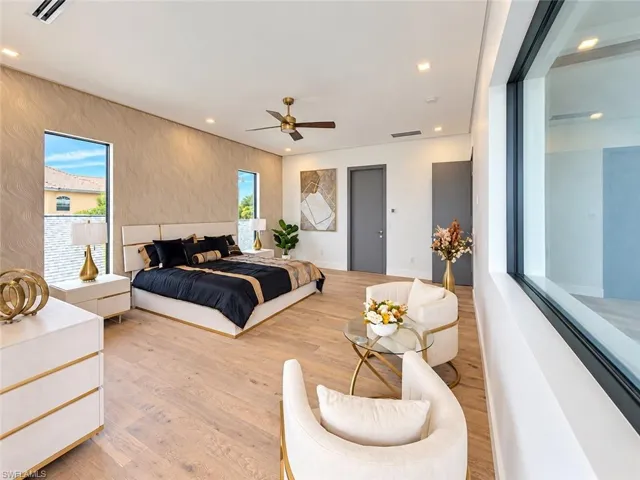 Spacious room featuring wood-finish flooring, recessed lighting, and a modern ceiling fan
