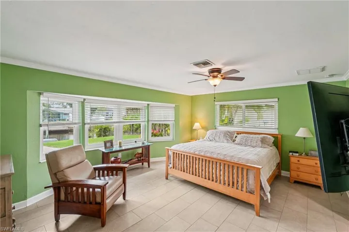 Bedroom featuring a ceiling fan and crown molding