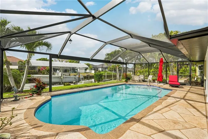 Outdoor pool with a sunroom, a lanai, and a patio area
