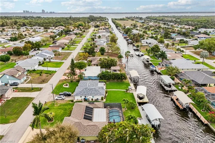 Aerial perspective of suburban area featuring a large body of water