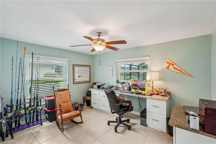 Office area featuring ceiling fan and light tile patterned floors