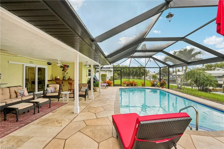 Swimming pool featuring a patio, outdoor lounge area, a sunroom, and a lanai