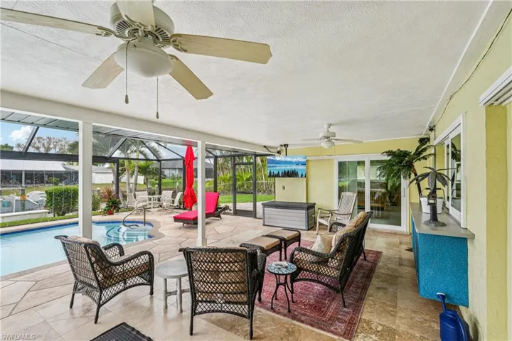 View of patio / terrace featuring ceiling fan, an outdoor hangout area, a sunroom, a lanai, and an outdoor pool