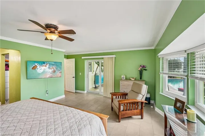 Bedroom with access to exterior, ceiling fan, crown molding, and tile patterned flooring