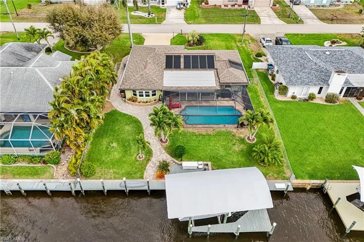 Aerial view of residential area featuring a pool area