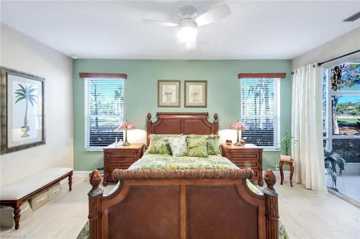Bedroom featuring wood finished floors, access to outside, and a ceiling fan