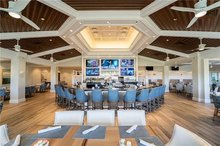 Bar area featuring a ceiling fan, dark countertops, and vaulted ceiling