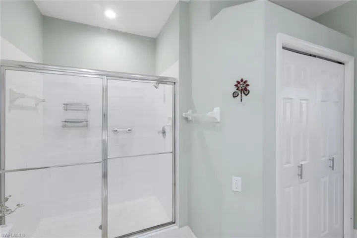 Bathroom with a stall shower and baseboards
