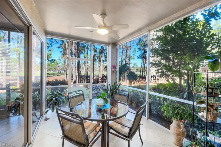 Sunroom / solarium with a ceiling fan and outdoor dining space