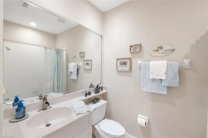 Full bath featuring vanity and curtained shower