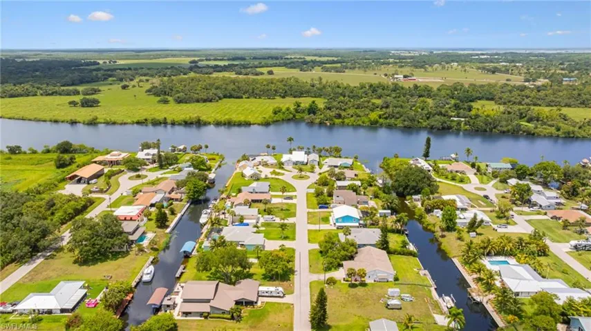 Aerial view of residential area featuring a nearby body of water
