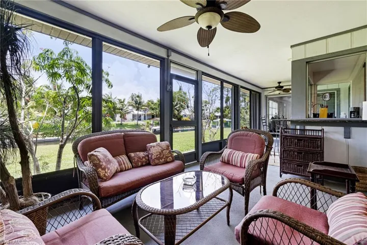 Sunroom with ceiling fan, outdoor lounge area, and healthy amount of natural light