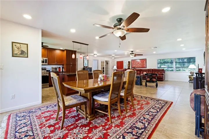 Dining room with a ceiling fan, recessed lighting, baseboards, and light tile patterned floors