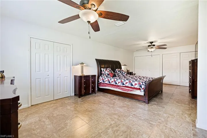 Bedroom featuring two closets and a ceiling fan
