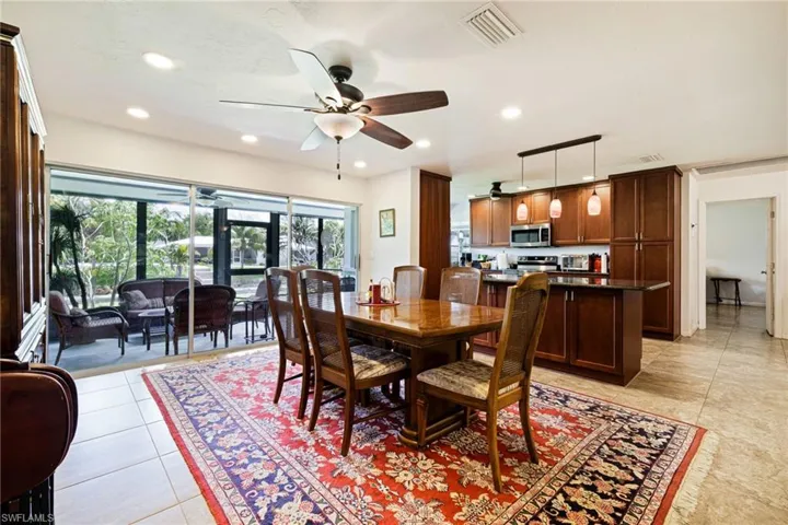 Dining room featuring a ceiling fan, recessed lighting, and light tile patterned flooring