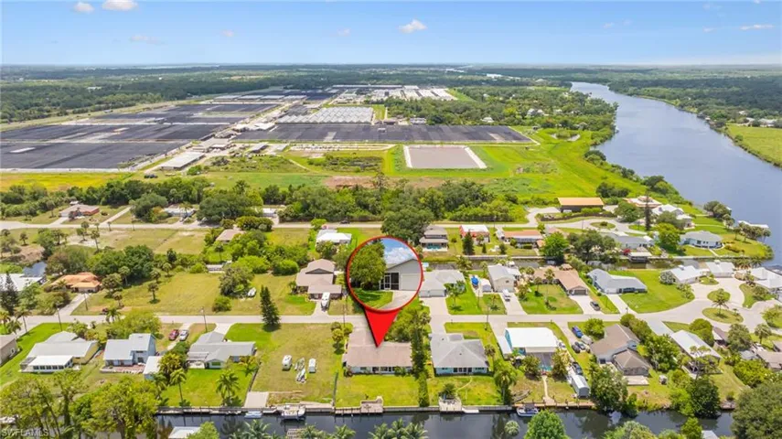 Aerial perspective of suburban area featuring a large body of water