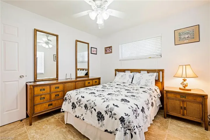 Bedroom featuring light tile patterned flooring and a ceiling fan