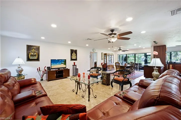 Living room with recessed lighting, a ceiling fan, and light tile patterned floors