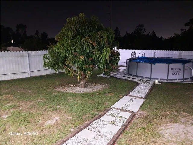 View of yard with a fenced in pool