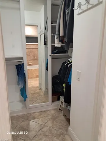 Spacious closet featuring light tile patterned floors