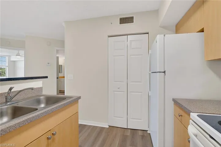 Kitchen featuring light wood-style floors, light wood finish cabinets