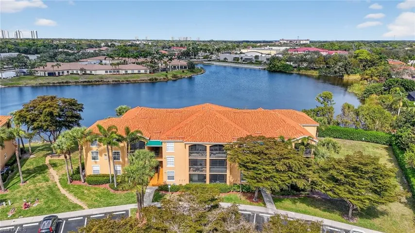 Drone / aerial view of a large body of water and a tree filled landscape