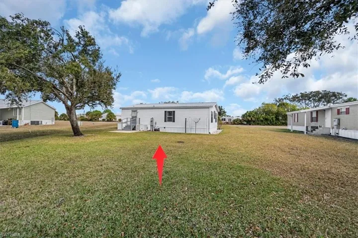 Back of property with a lawn