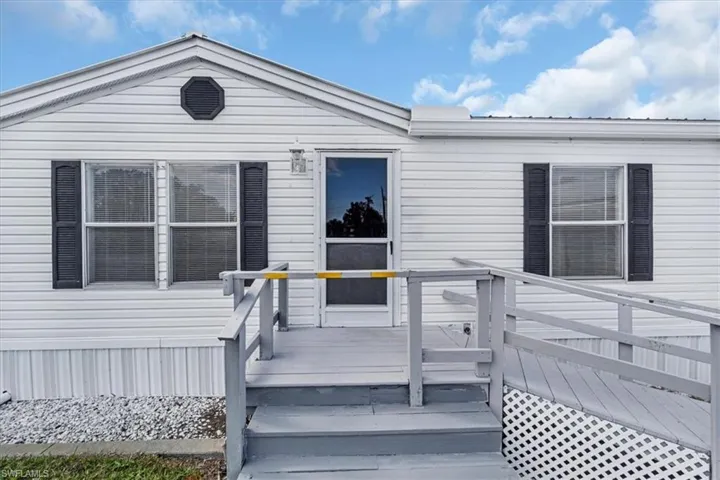 Doorway to property with a deck