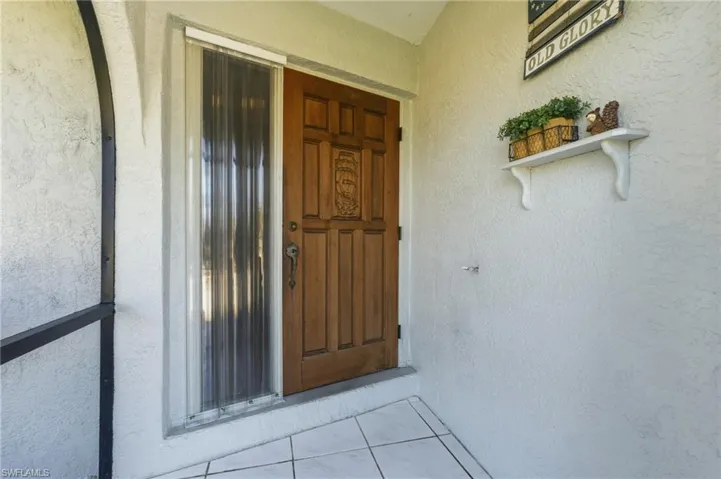 View of exterior entry featuring stucco siding