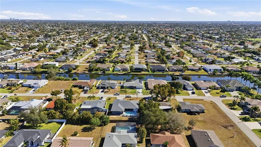 Aerial overview of property's location featuring nearby suburban area and a large body of water