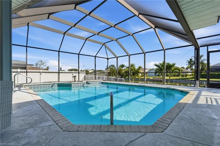 Outdoor pool with a lanai, a sunroom, and a patio area