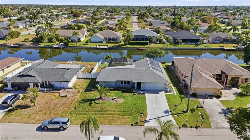 Aerial perspective of suburban area featuring a nearby body of water