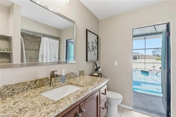 Full bath with vanity, a shower with curtain, and light tile patterned floors