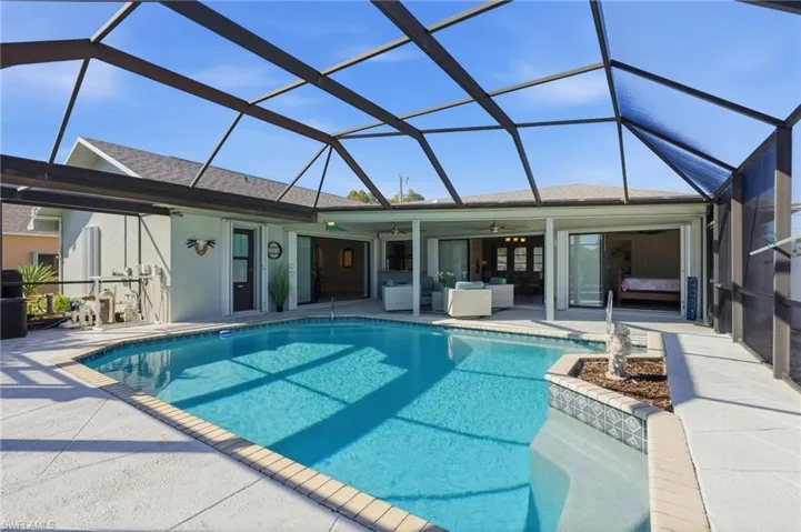 Outdoor pool featuring a sunroom, a lanai, a patio area, and outdoor lounge area