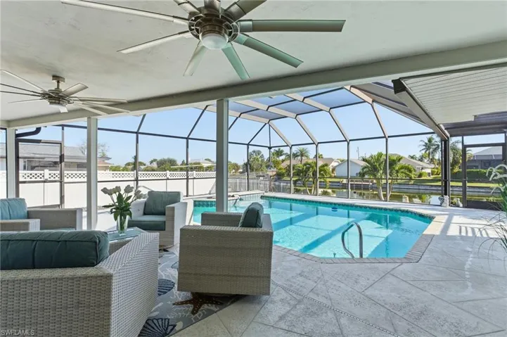 Outdoor pool featuring outdoor lounge area, a lanai, a sunroom, and a patio