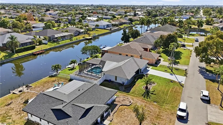 View of property location featuring a large body of water and nearby suburban area