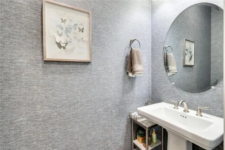 Bathroom featuring a sink and decorative backsplash