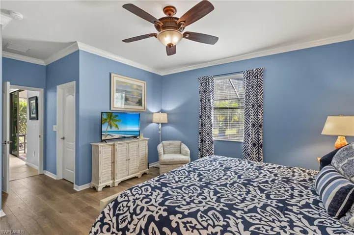 Bedroom with hardwood / wood-style flooring, ceiling fan, access to exterior, and crown molding