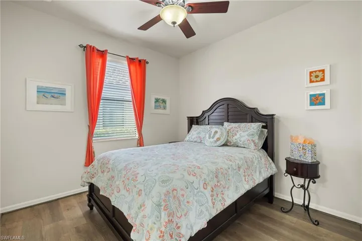 Bedroom featuring ceiling fan and hardwood / wood-style flooring