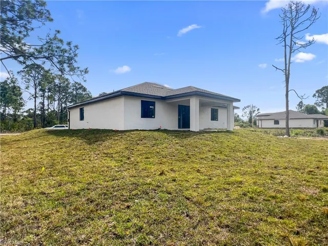 Back of house with a yard