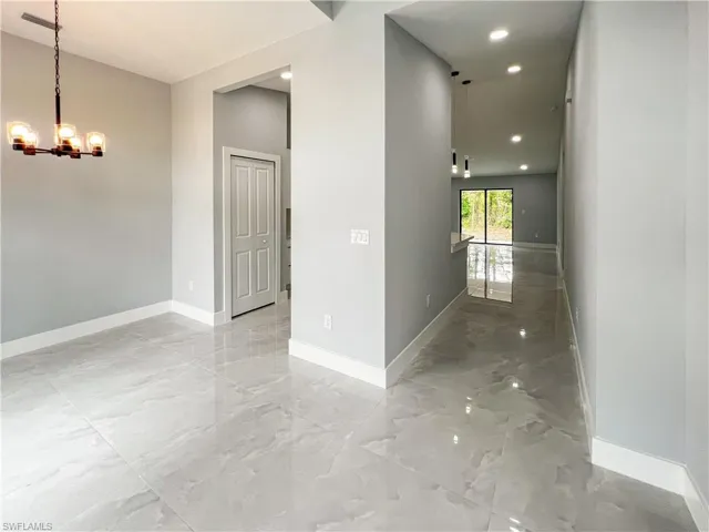 Corridor featuring a chandelier